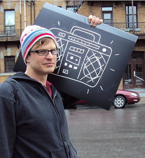 Jef Czekaj holding a cardboard boombox